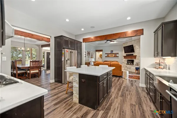 a open kitchen with stainless steel appliances granite countertop a lot of counter space and wooden floors