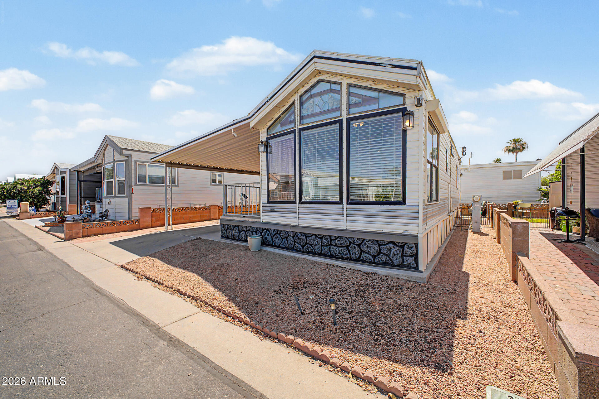 7750 East Broadway Road, Unit 560 Mesa, AZ 85208 - Photo 2 of 18 a front view of a house with large windows