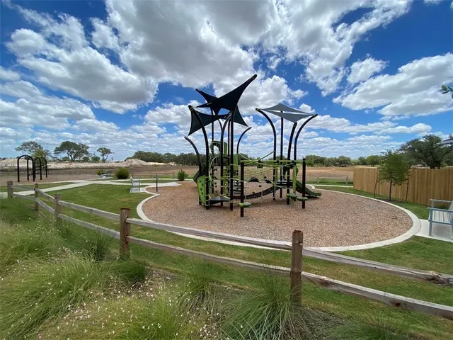 a view of a house with a wooden fence