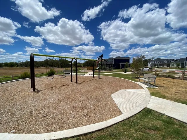 a view of a swimming pool with a yard