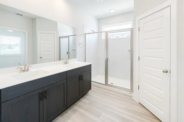 an empty room with closet and a chandelier fan