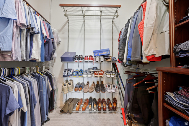 1389 Millbrook Way Bountiful, UT 84010 - Photo 37 of 74 Custom closet system featuring multiple hanging rods, wire shelving, and built-in wood-finish shelving units