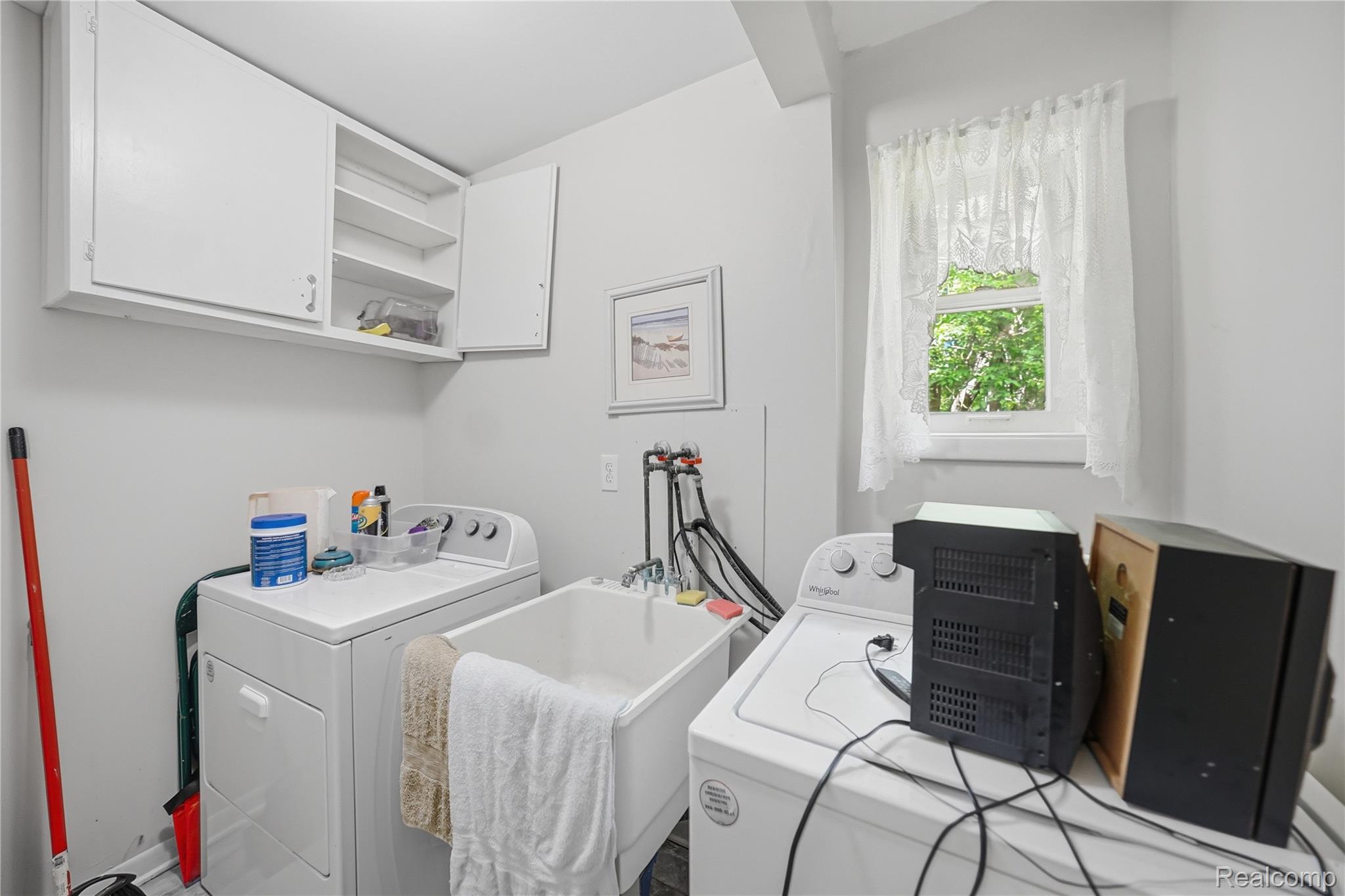 6790 Weyer Road Imlay City, MI 48444 - Photo 25 of 34 Dedicated laundry area featuring a utility sink, upper cabinetry for storage, and a single window