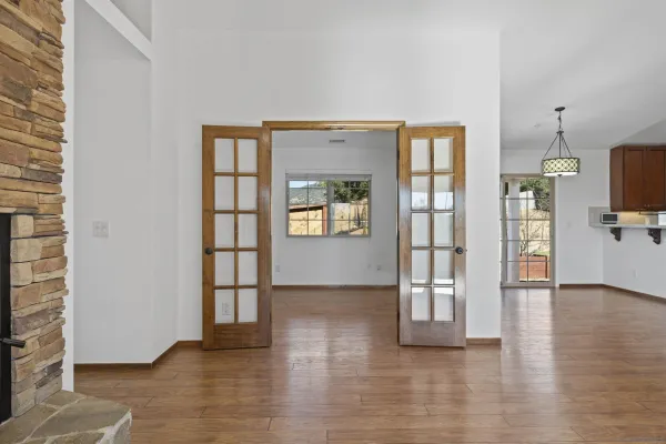an empty room with wooden floor and a window
