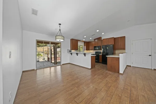 a kitchen with stainless steel appliances granite countertop wooden cabinets a sink and a stove