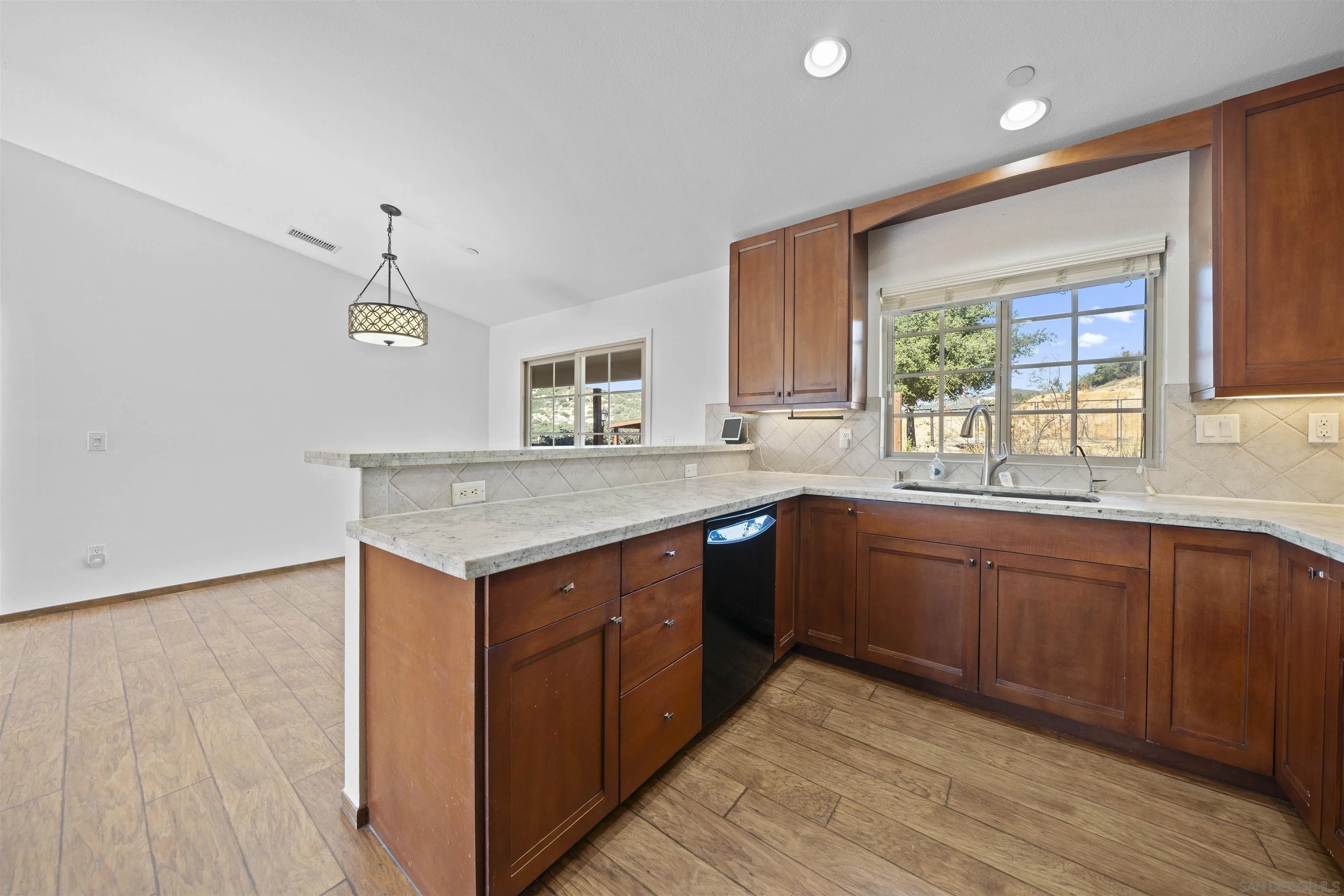 20872 Deerhorn Valley Road Jamul, CA 91935 - Photo 17 of 64 a kitchen with a stove a sink and a window