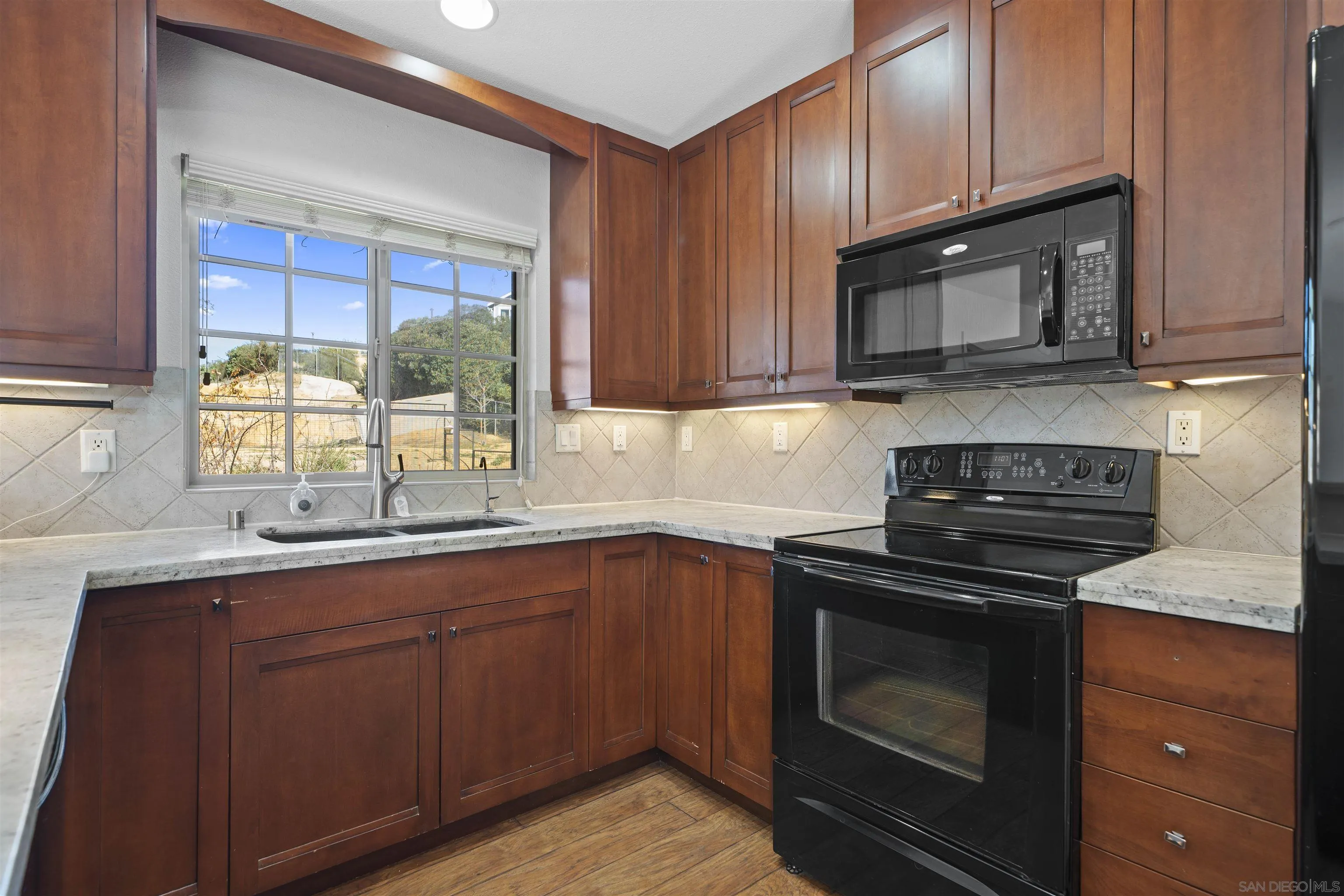 20872 Deerhorn Valley Road Jamul, CA 91935 - Photo 19 of 64 a kitchen with sink cabinets and stainless steel appliances
