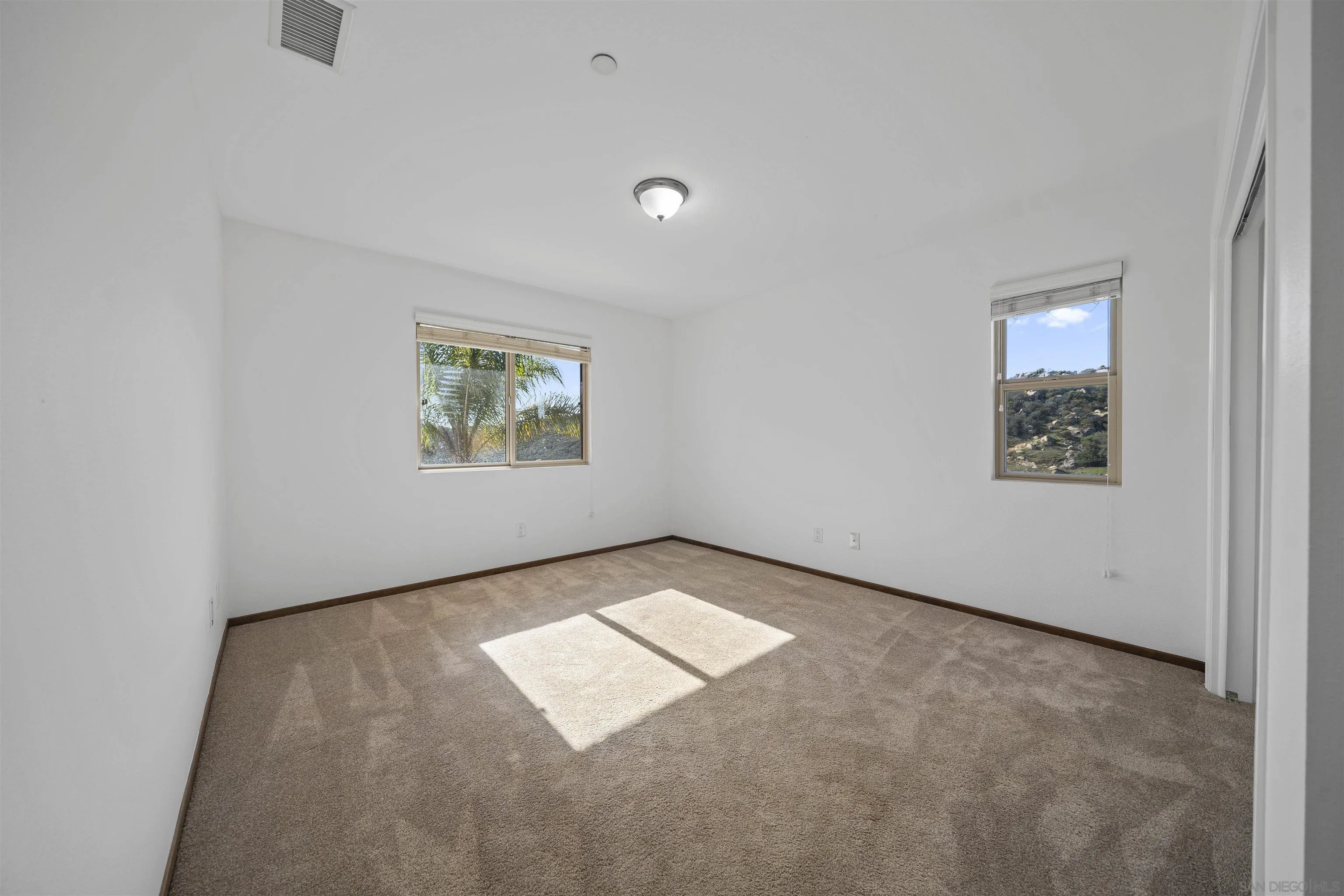 20872 Deerhorn Valley Road Jamul, CA 91935 - Photo 25 of 64 an empty room with windows