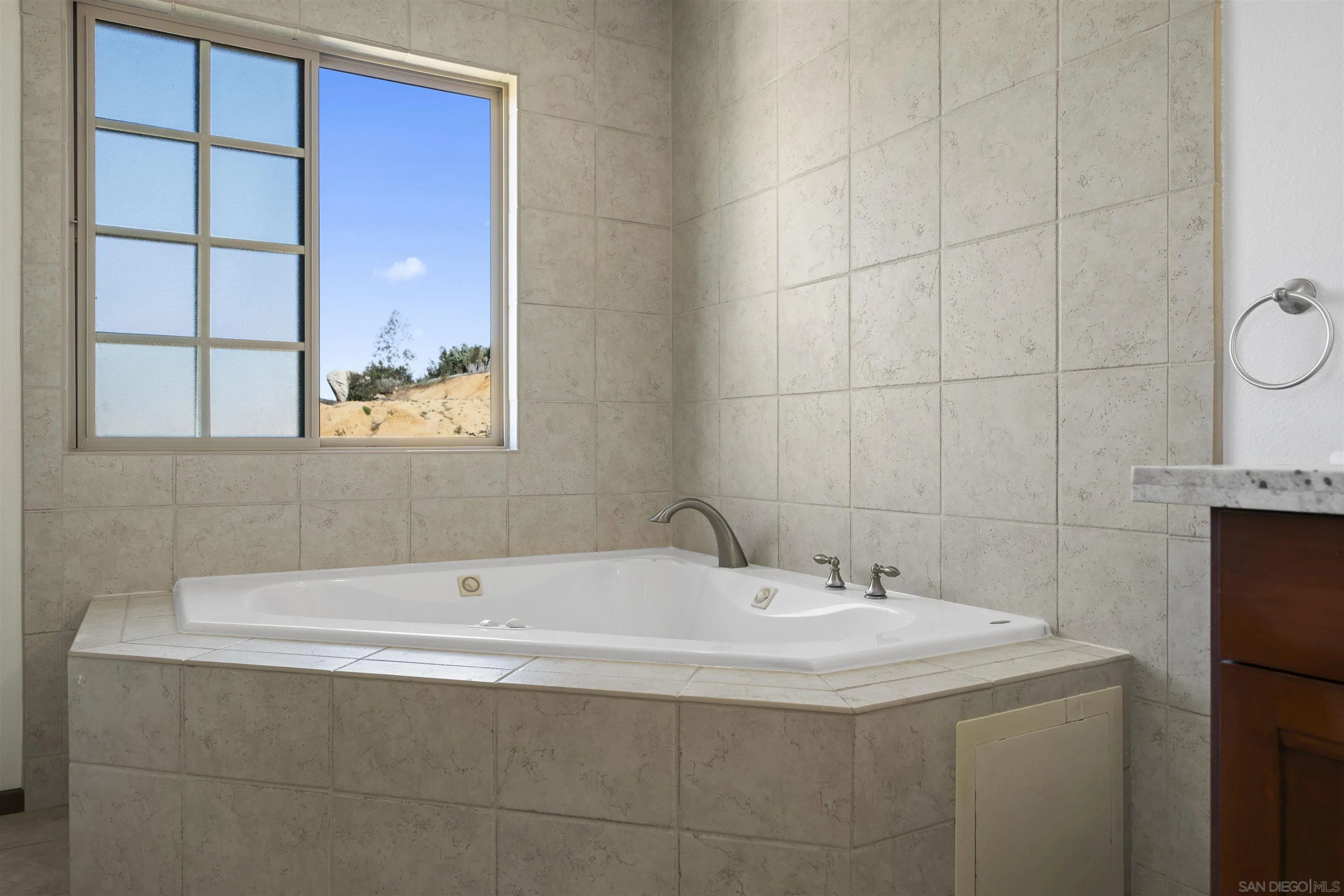 20872 Deerhorn Valley Road Jamul, CA 91935 - Photo 36 of 64 a bathroom with a sink and a bathtub