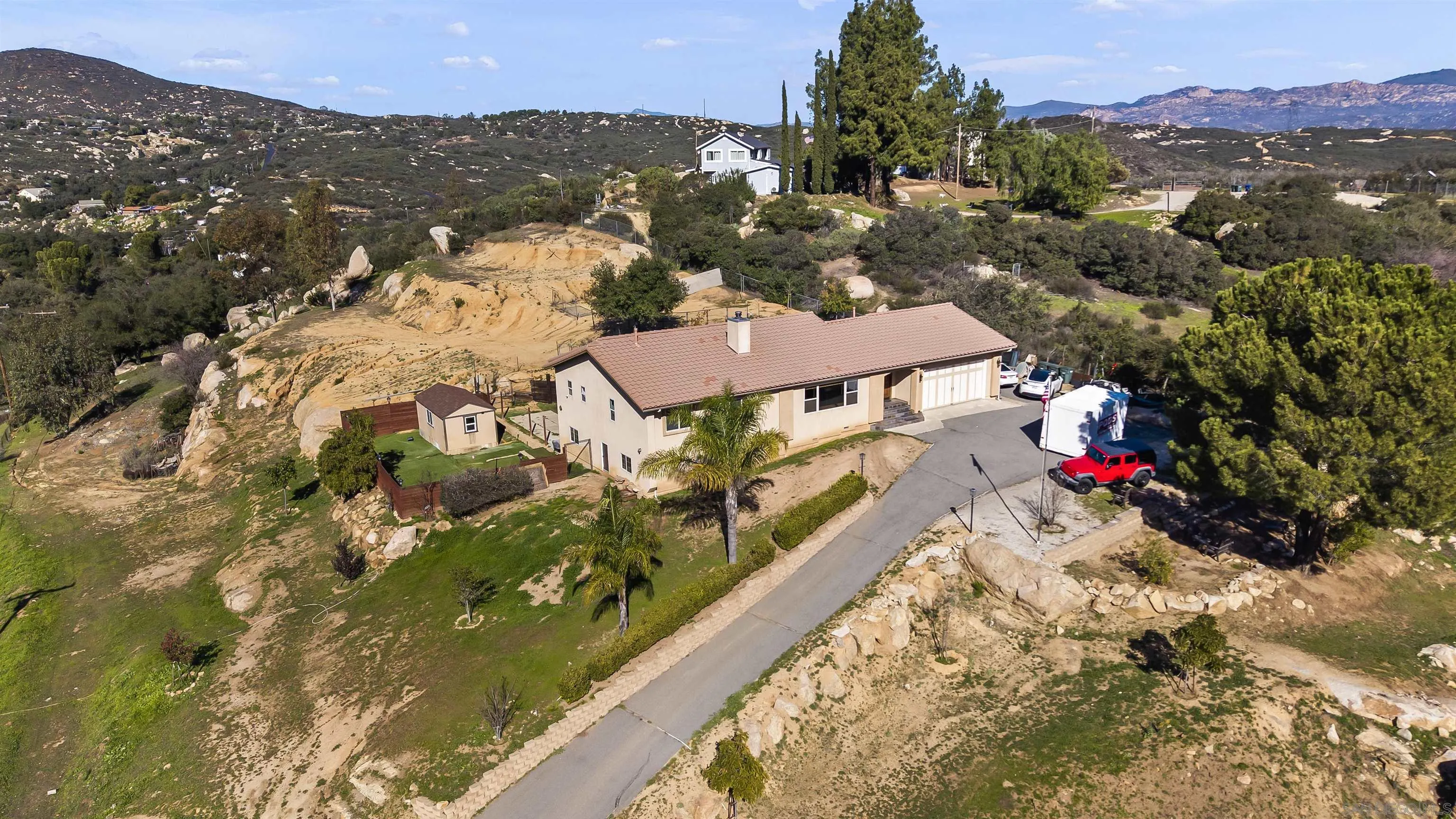 20872 Deerhorn Valley Road Jamul, CA 91935 - Photo 64 of 64 an aerial view of residential houses with outdoor space and trees