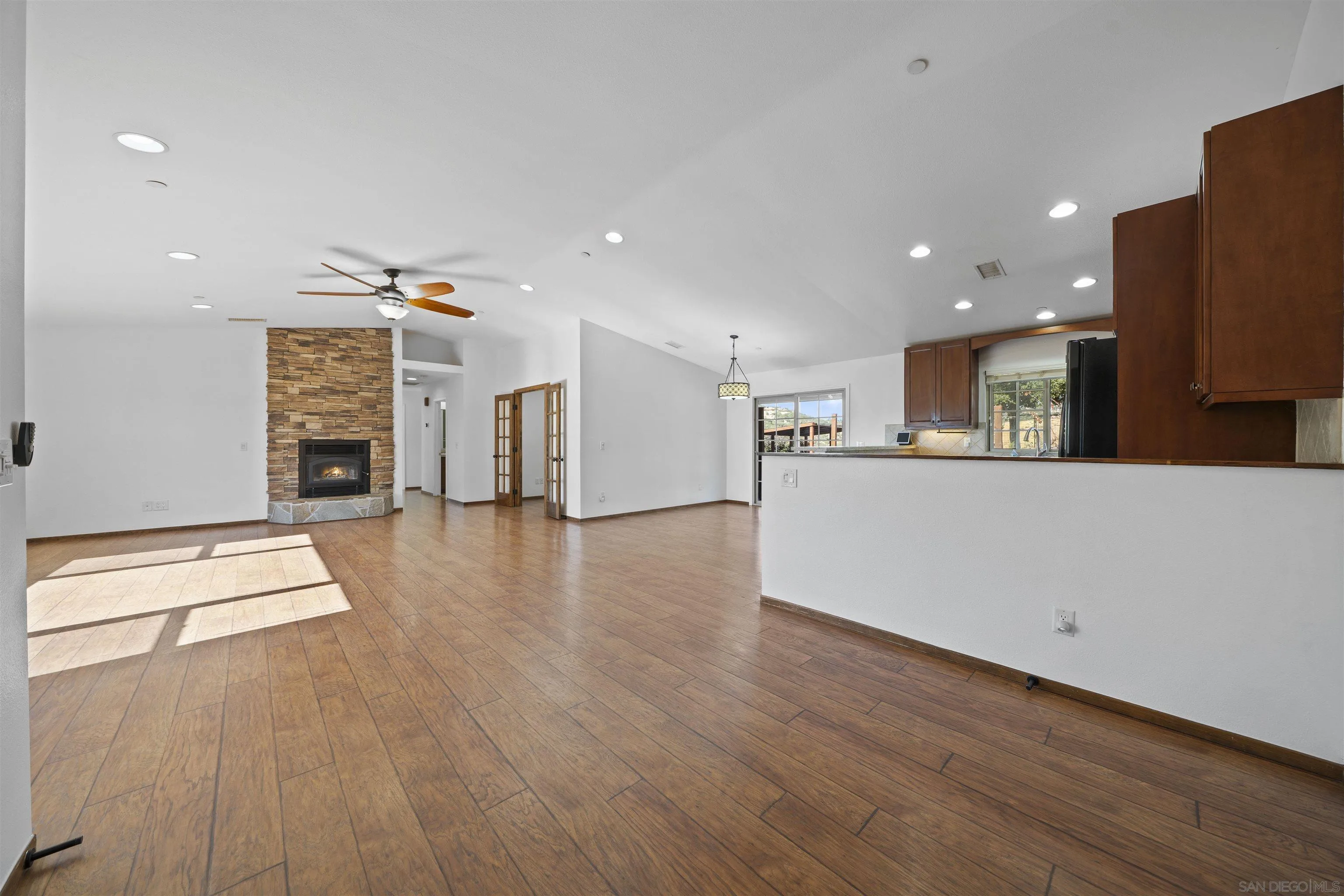 20872 Deerhorn Valley Road Jamul, CA 91935 - Photo 7 of 64 a view of a big room with wooden floor and a fireplace