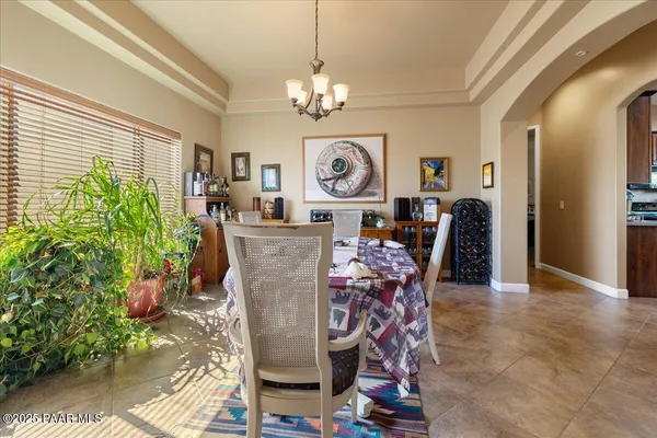 a dining room filled with furniture and window