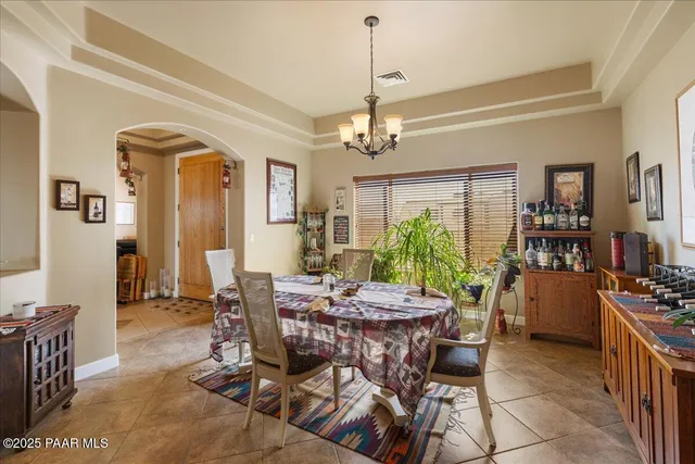 a view of a dining room with furniture and a chandelier