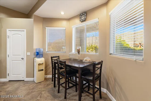 a dining room with furniture and window