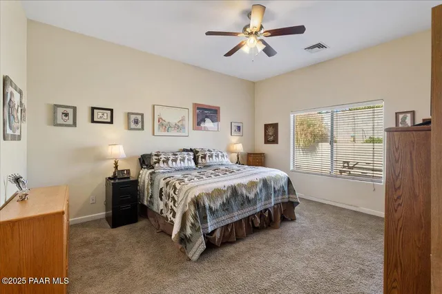 a spacious bedroom with a bed and a chandelier