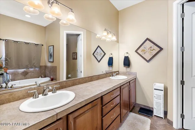 a en suite bathroom with a sink and a mirror