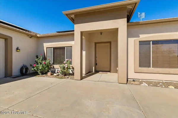 a view of a house with potted plants