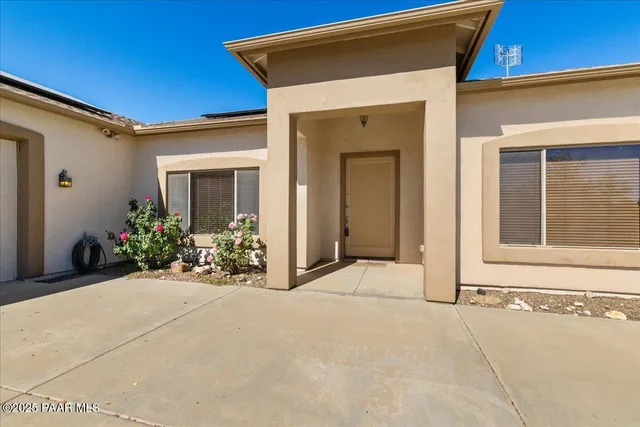 a view of a house with potted plants