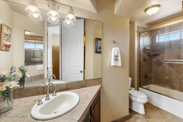 a bathroom with a toilet a sink and a mirror