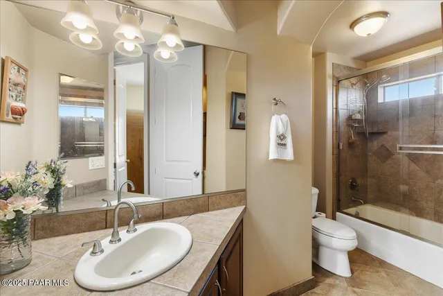a bathroom with a toilet a sink and a mirror
