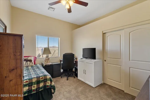 a bedroom with bed and tv