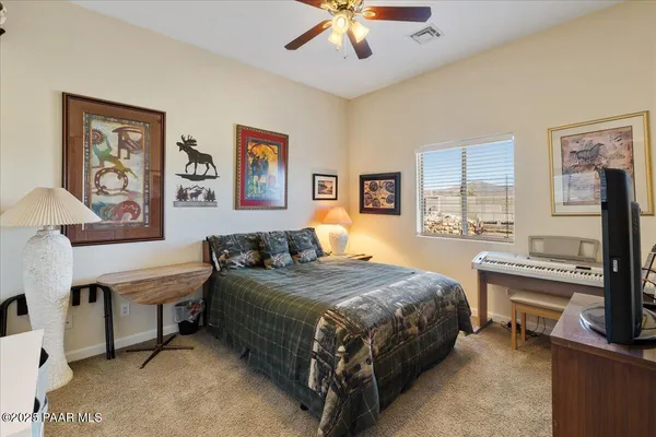 a bedroom with a bed and a desk