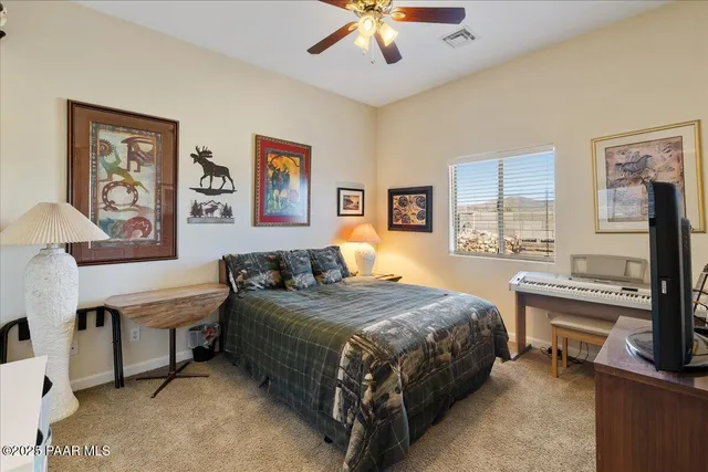 a bedroom with a bed and a desk