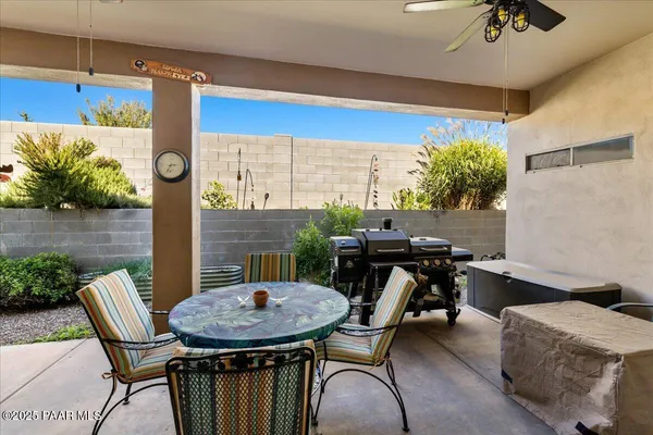 a view of a patio with table and chairs with wooden floor and plants
