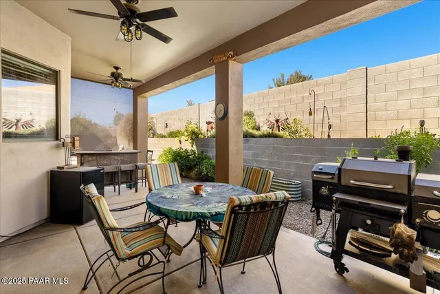 a view of a patio with a table and chairs