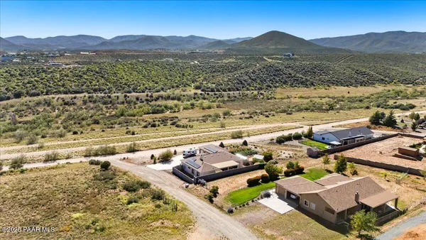 an aerial view of residential houses with outdoor space