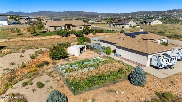 an aerial view of residential houses with outdoor space and trees
