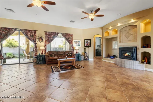 a living room with furniture a fireplace and a chandelier