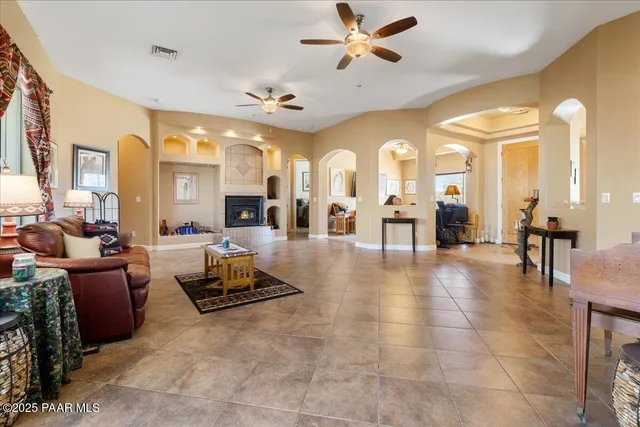 a living room with lots of furniture and view of a large window
