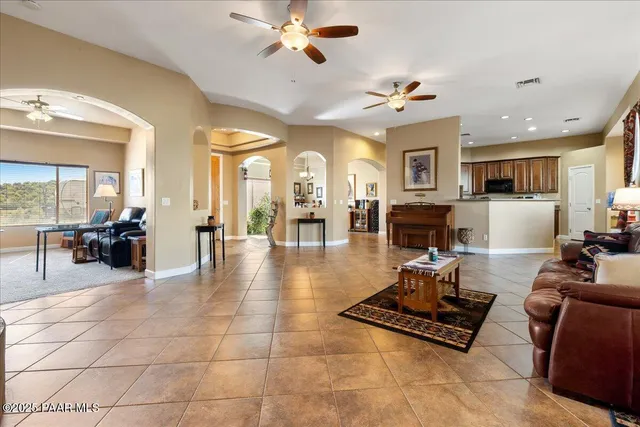 a living room with furniture a dining table and a fireplace