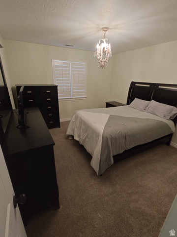 552 Sunset Crest Way Draper, UT 84020 - Photo 32 of 68 Bedroom with dark carpet, a textured ceiling, and a chandelier