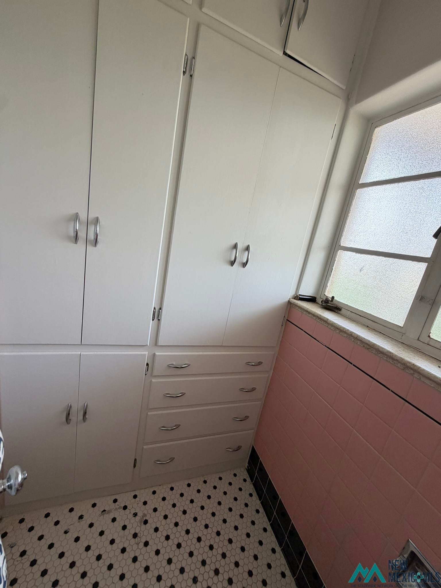 570 Curry Road North Clovis, NM 88101 - Photo 52 of 59 Built-in white cabinetry with chrome hardware and four drawers provides extensive storage