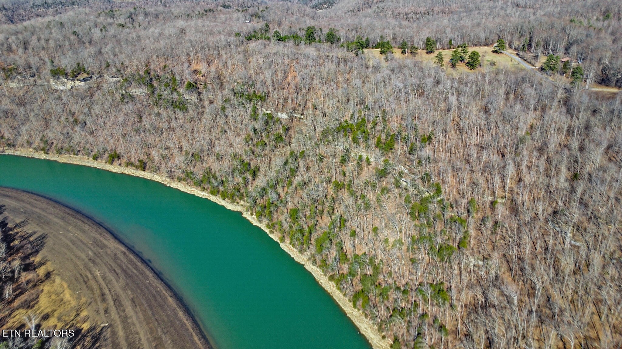 5031 Robbinstown Road Byrdstown, TN 38549 - Photo 14 of 60 a view of a lake with a yard and large trees
