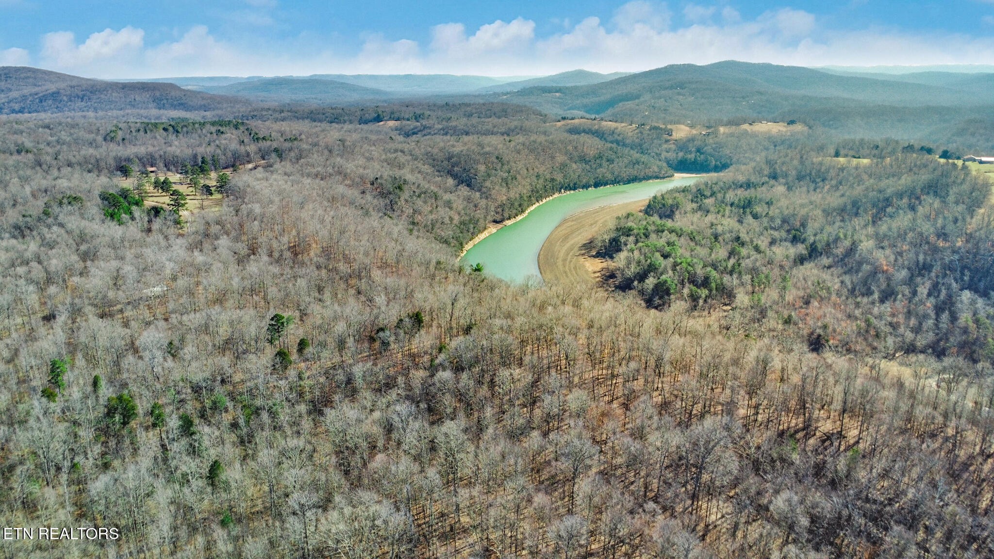5031 Robbinstown Road Byrdstown, TN 38549 - Photo 5 of 60 a view of a lush green hillside and a building