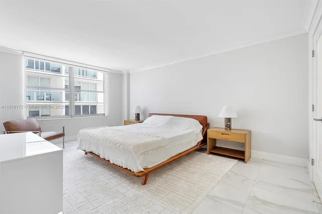 a bed room with a bed and a chair