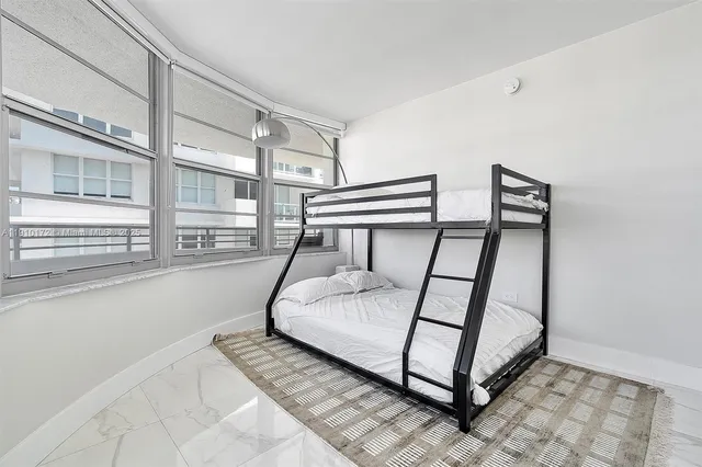 a view of staircase with a rug and a window
