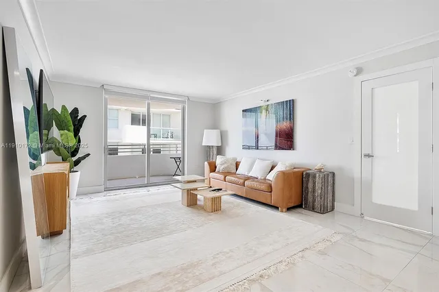 a living room with furniture potted plant and a large window