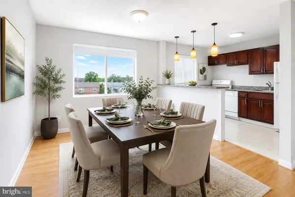 a view of a dining room with furniture and a kitchen