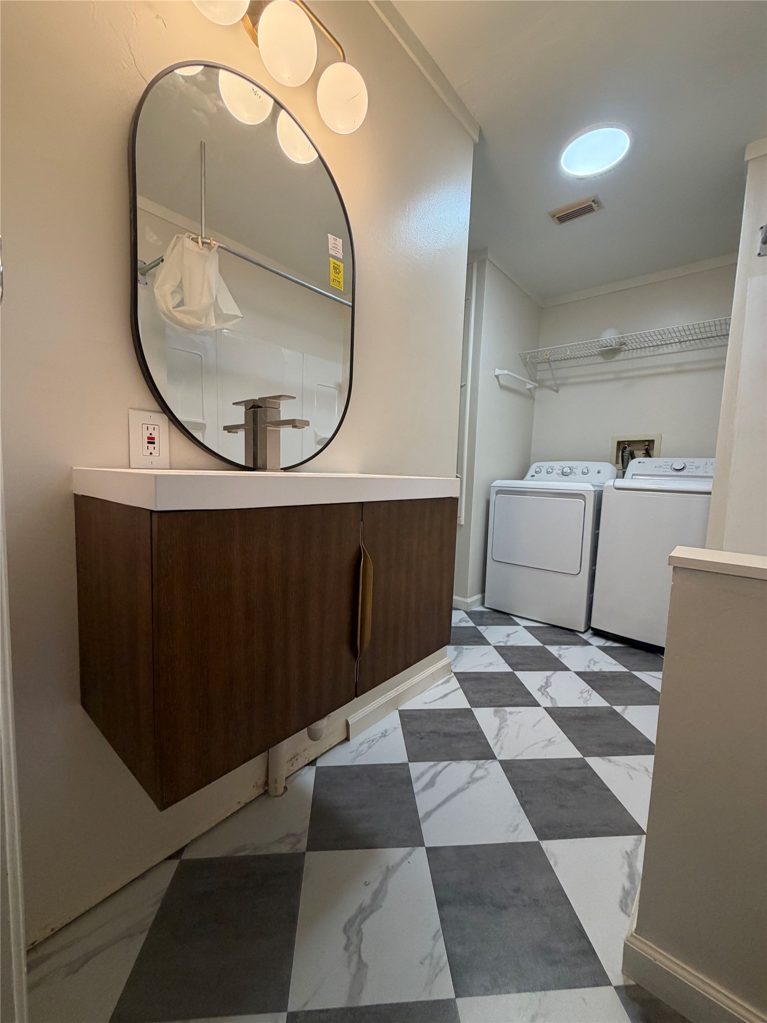 214 The Forest Road Dale, TX 78616 - Photo 11 of 18 A well-equipped laundry space with checkerboard flooring provides practical daily convenience.