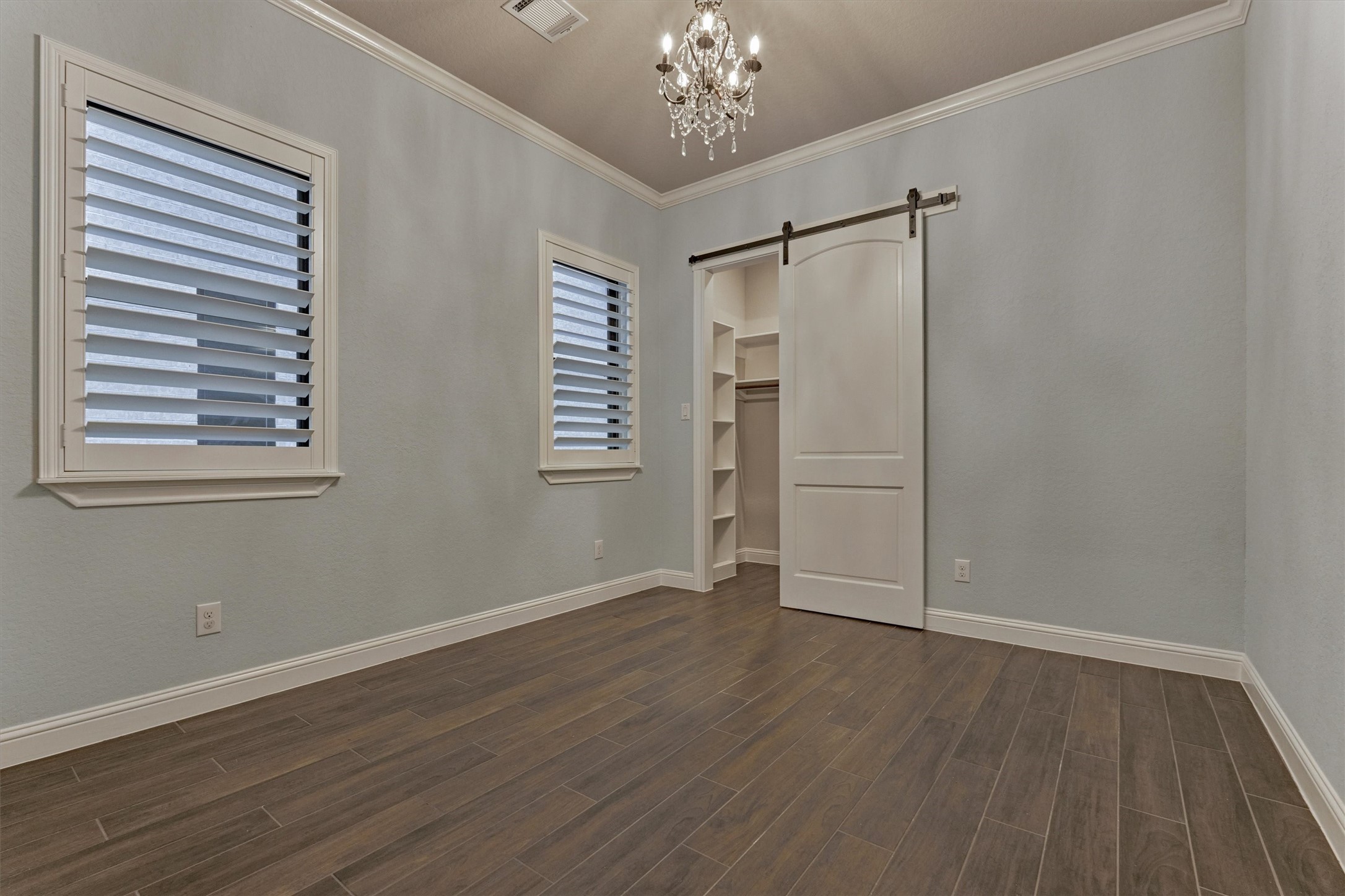 11618 Renaissance Drive Montgomery, TX 77356 - Photo 27 of 49 A second guest bedroom on the first floor also has custom wood shutters, a cute chandelier and walk-in closet with built-ins cabinetry.