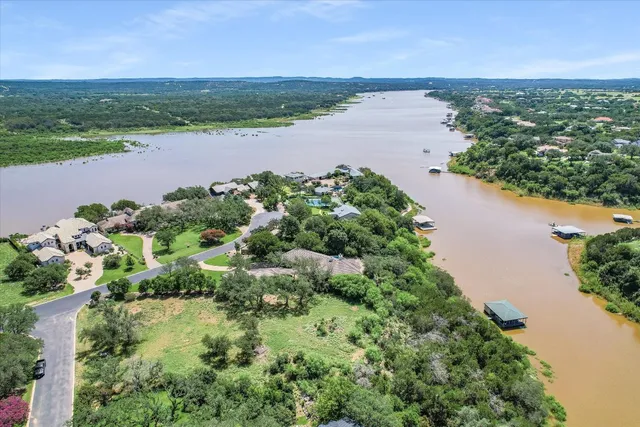 an aerial view of a houses with outdoor space and ocean view