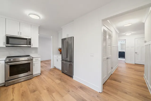 a kitchen with stainless steel appliances and a fireplace
