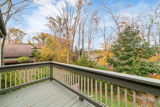 a view of balcony with wooden floor and fence
