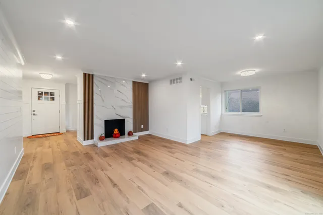 a view of a livingroom with an empty space and a fireplace