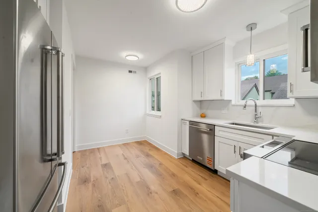a kitchen with a sink stove and refrigerator