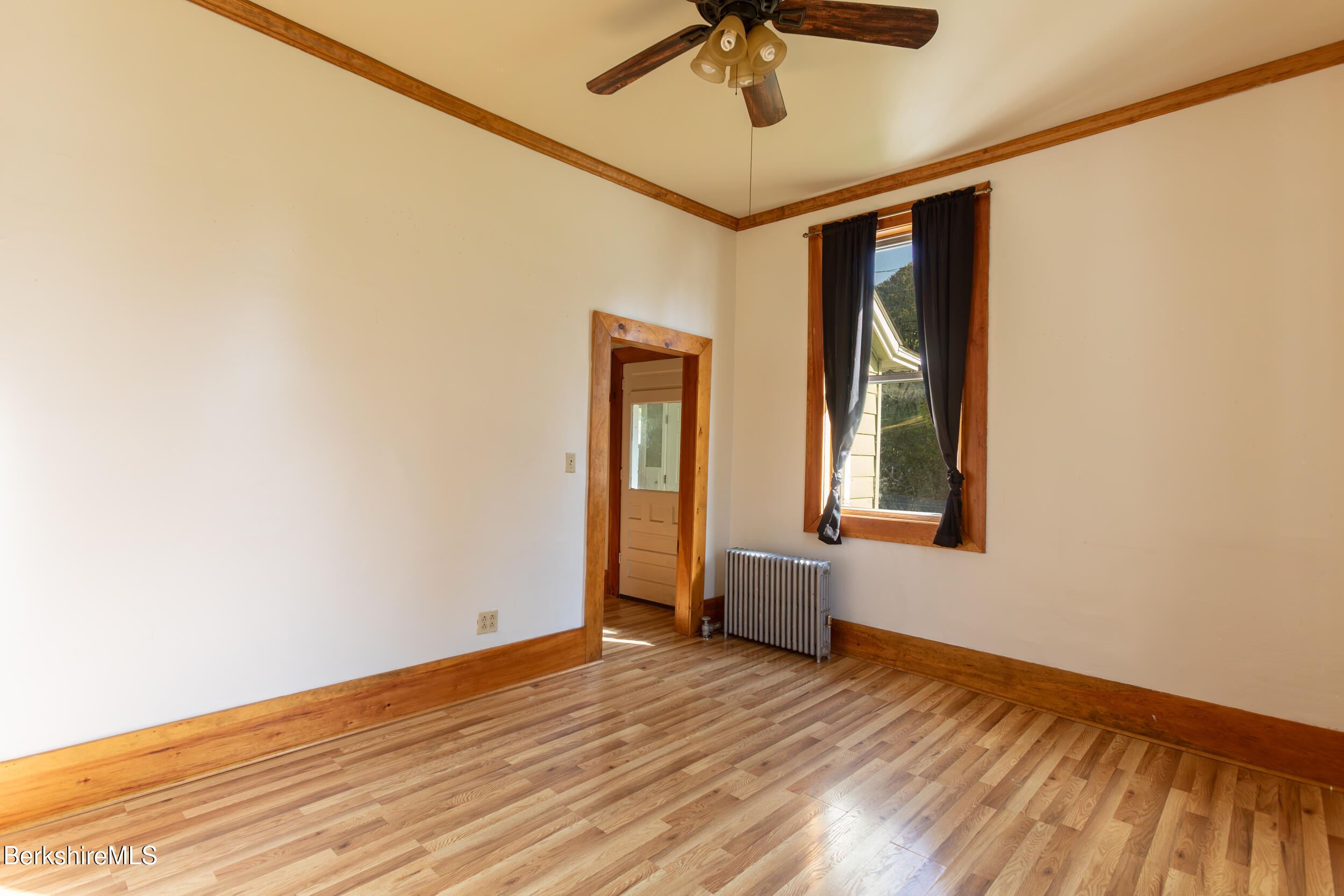 89-91 Pecks Road Pittsfield, MA 01201 - Photo 13 of 28 a view of an empty room with a window and wooden floor